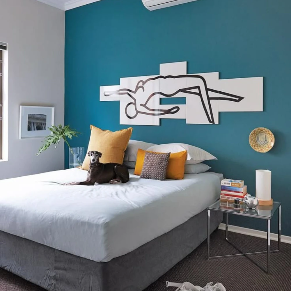 Painter applying paint in bedroom